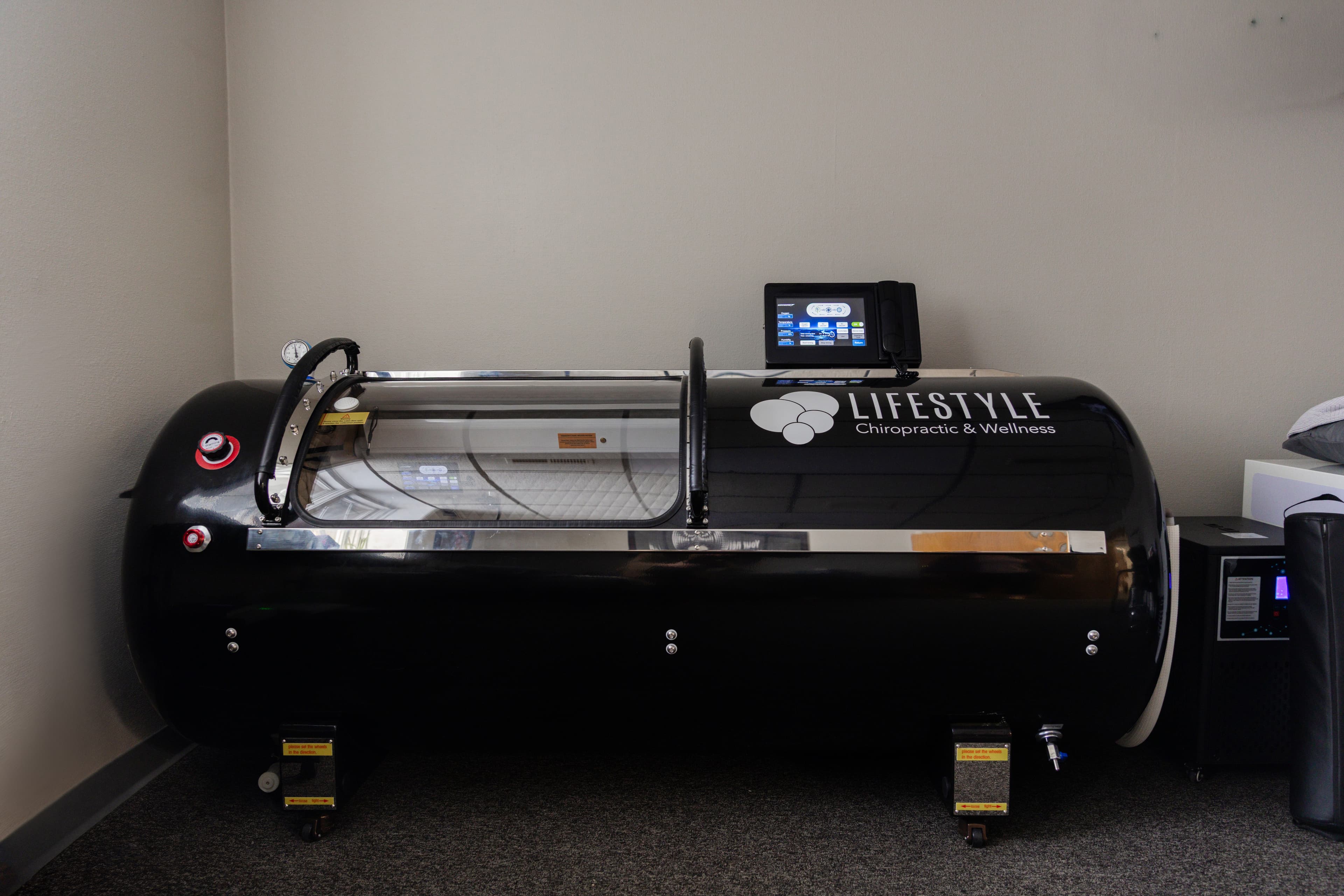 Person relaxing inside a Tesla Med Bed hyperbaric-style chamber